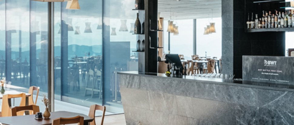 Current news and stories from Olang Modern restaurant with wooden chairs and large windows showing mountain views