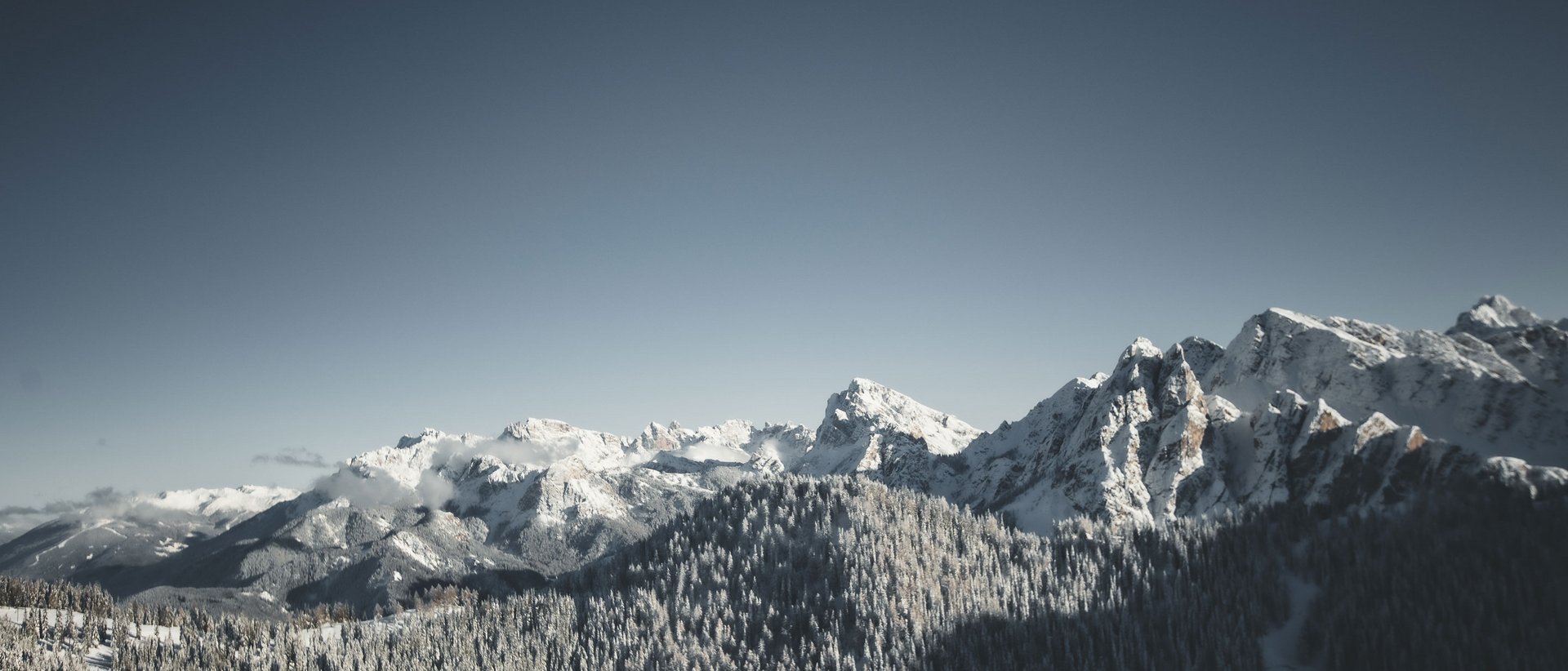 Our wellness hotel in Val Pusteria for relaxation seekers Snow-covered mountains under a clear sky