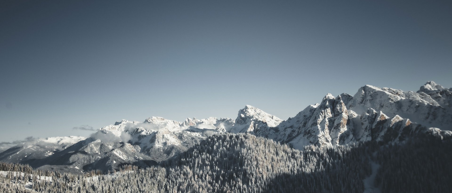 Our 5-star hotel in Italy between heaven and earth Snow-covered mountains under a clear sky