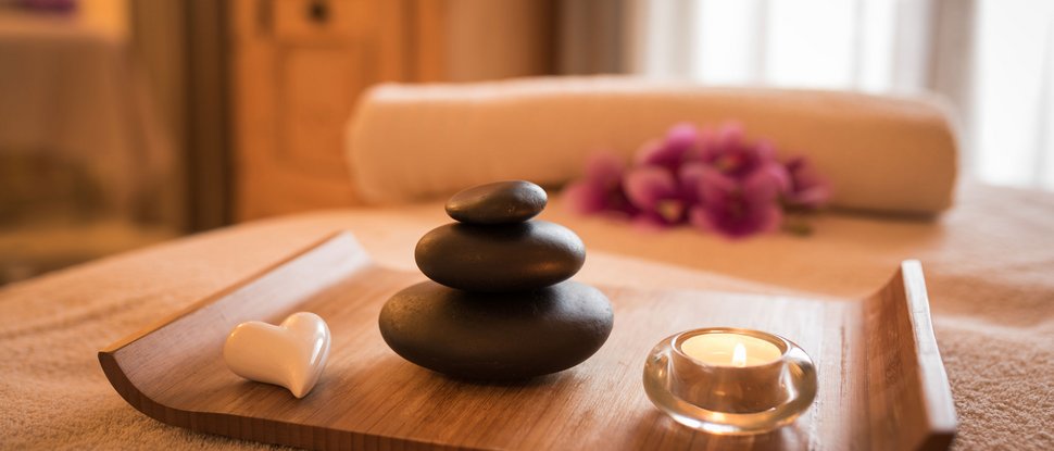 Ultime novità e storie da Valdaora Scena rilassante spa con pietre da massaggio, candela e cuore decorativo su vassoio