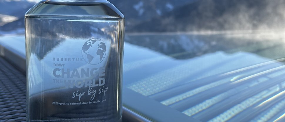 Current news and stories from Olang Clear glass bottle with water against mountain landscape and blue sky