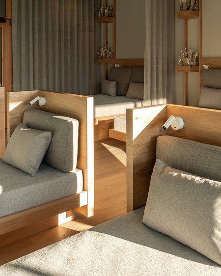 Il nostro hotel a Valdaora tra cielo e terra Sala relax moderna con lettini comodi e decorazioni in legno alla luce naturale