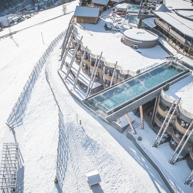 Awards & Press Modern building with heated outdoor pool overlooking snowy slope