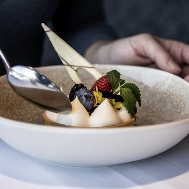A place to enjoy Elegant dessert with berries and cream on a white plate