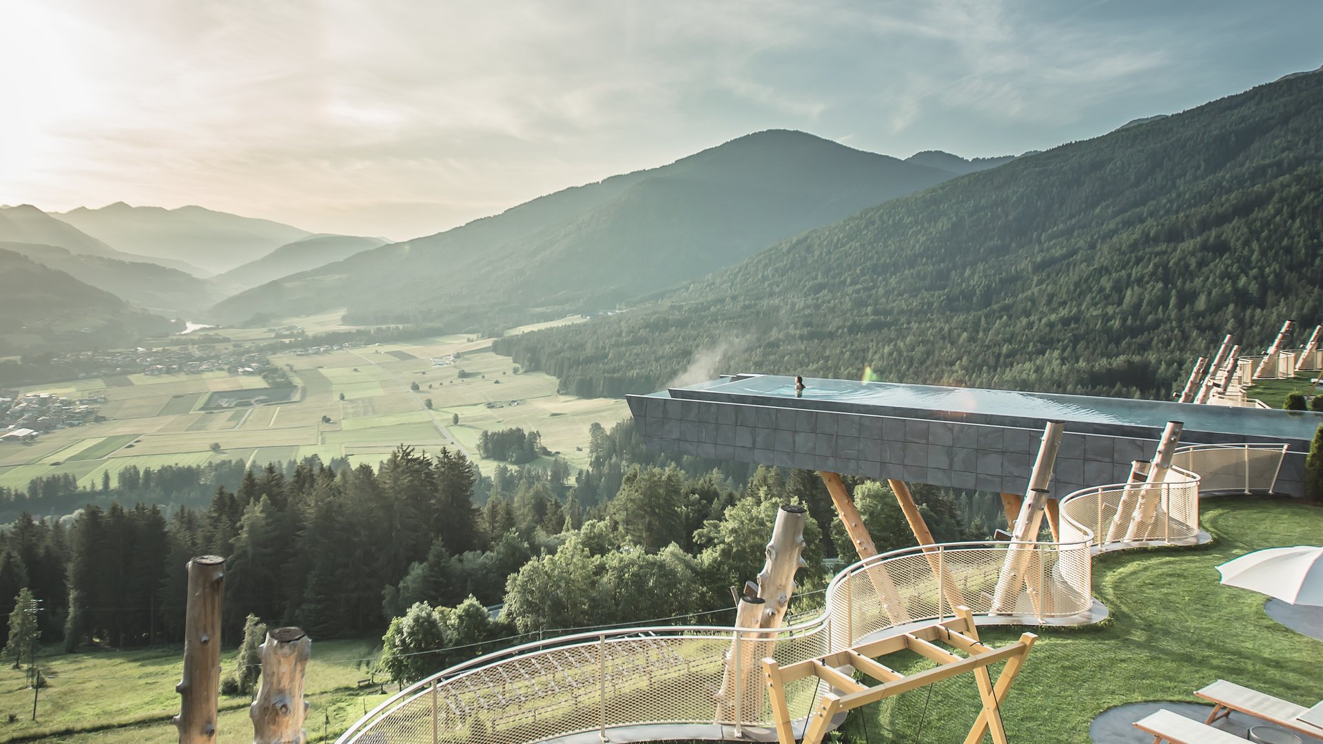 Our Sky Pool in South Tyrol, a rare beauty Sunny terrace with loungers, swings, and mountain valley view